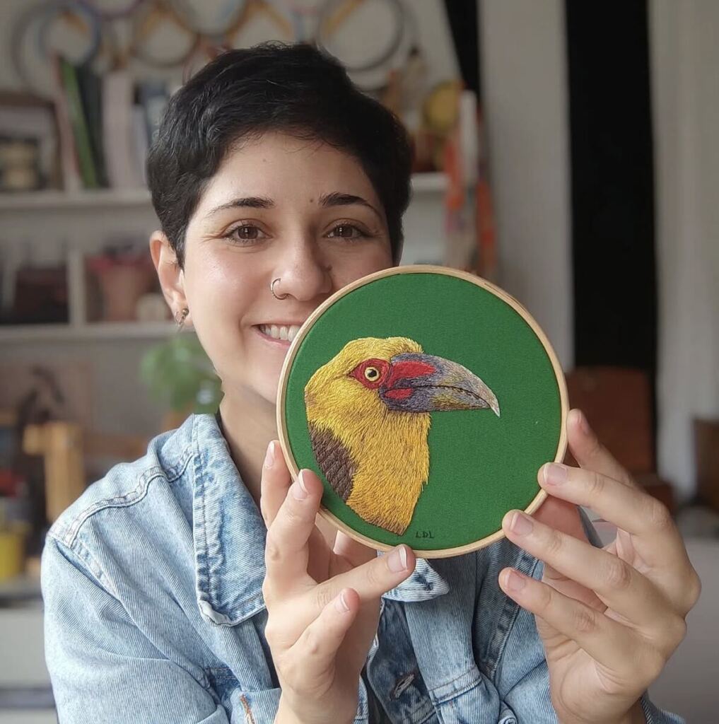 World Migratory Bird Day 2026 artist, Luisa Lacerda with a piece of her art